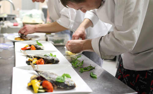 Chef plating up in professional kitchen